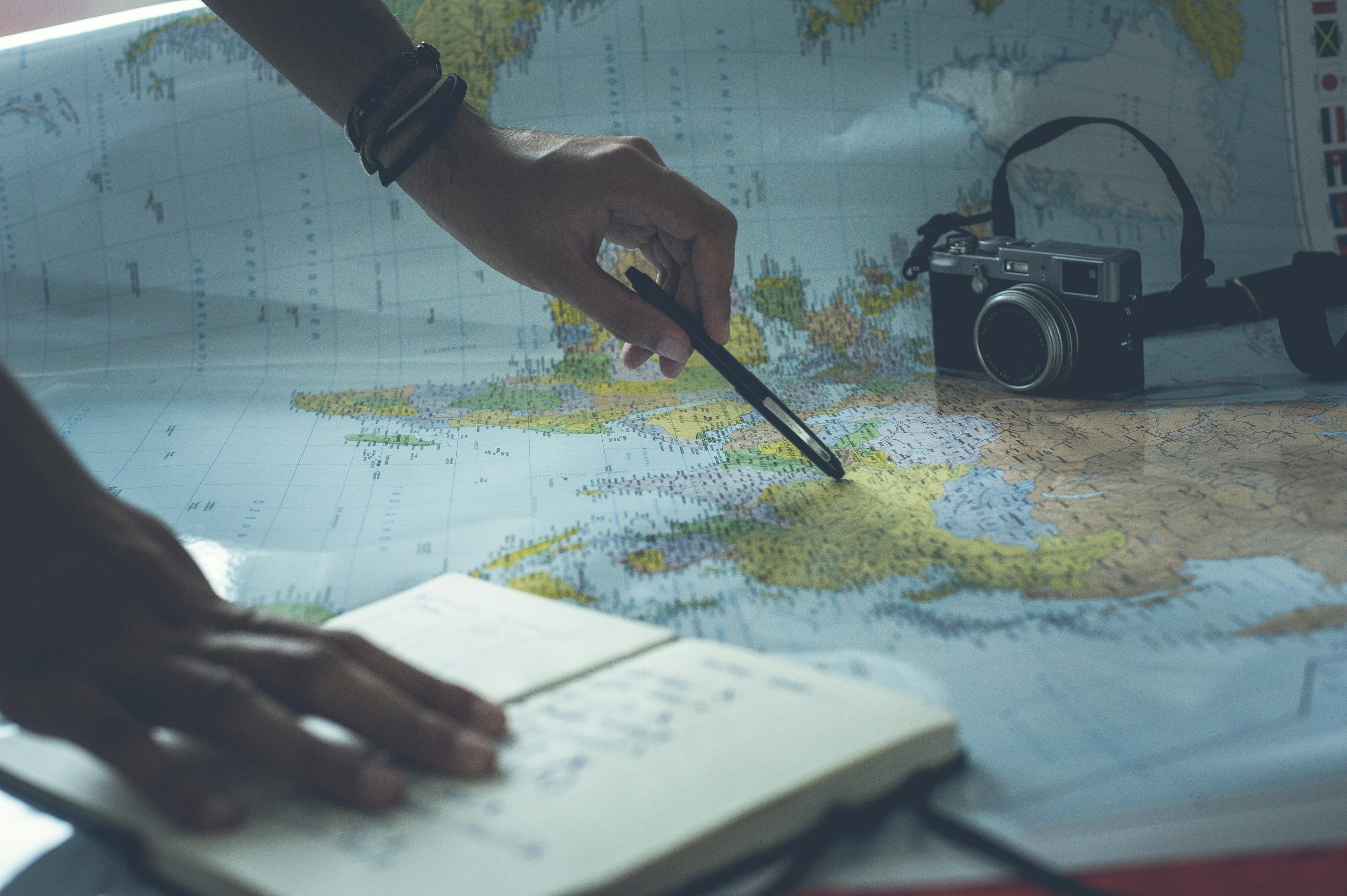 Person planning travel itinerary with map