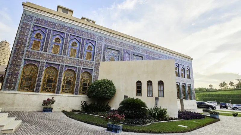 Katara Masjid exterior covered in blue and gold tilework